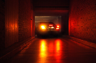 Parking car in garage at night.