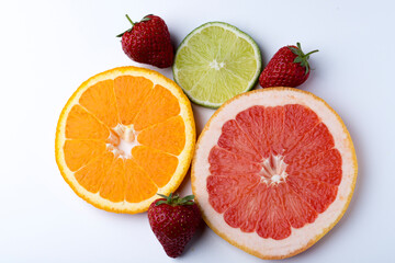 Orange grapefruit Strawberry and lime citruses on a white background isolate
