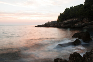 Photo of sundown at the beach in montenegro. Beautiful scenery. waves in the motion in foreground. Ulcinj. 