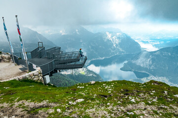 Woman at the 5 Fingers observation platform on top of the Krippenstein mountain, enjoying the stunning view of the Salzkammergut region, OÖ, Austria