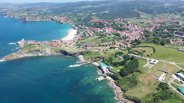 Scenic view from drone of coastal Spanish township of Comillas on sunny summer day, Cantabria
