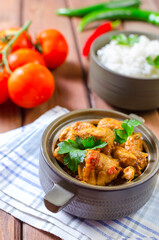 Fresh homemade chicken curry with chilly in vintage ceramic bowl. Selective focus.