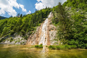 View of a waterfall (Traun-Ursprung) splashing from the Dead Mountains into the legendary Lake Toplitz, Ausseer Land region, Styria, Austria