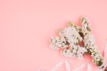 Obraz premium Spring bouquet and lace on pink background. White lilac.
