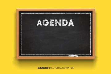 Hand writing the word Agenda with white Chalk inscription on a blackboard. Chalkboard 3D. Realistic black boards in a wooden frame isolated on a yellow background.