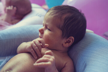 Newborn baby boy lying on bed