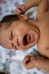 Fototapeta na wymiar Newborn baby boy lying on bed