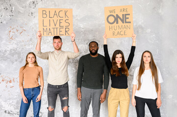A protest against cruelty and racism. Multi-racial group of young people with signs 