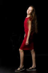 Fototapeta na wymiar Beautiful Girl with Long Hair Posing in Red Dress and Black Shoe