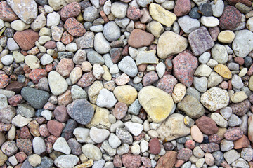 Abstract background with dry pebbles of different shapes.