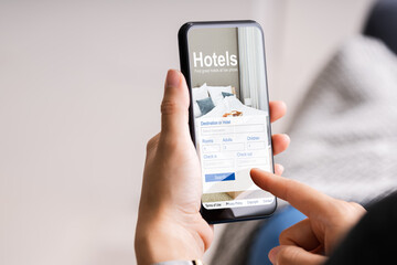 Holding Smart Phone Booking Hotel Online