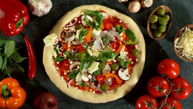 Super slow motion of falling mozzarella and basil on pizza dough. Filmed on high speed cinema camera, 1000 fps.