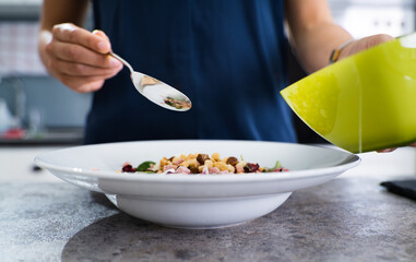 Woman Cooking Salad In Kitchen