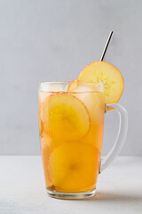 Homemade fermented cider with ice in a tall glass cup. Healthy refreshing non-alcoholic cocktail. Copy space.