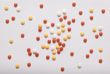 Yellow, white and red pills isolated on white as a background 