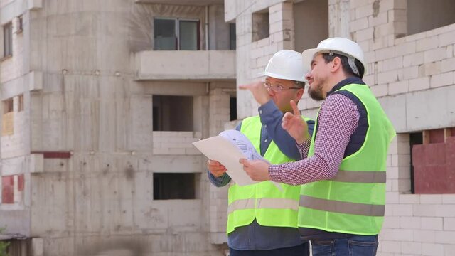 Construction Engineer discussion with Architect at Construction Site