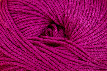 Yarn for knitting close-up background. Magenta, pink