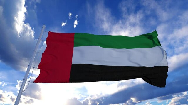 Realistic Flag of United Arab Emirates waving at wind in slow with blue sky