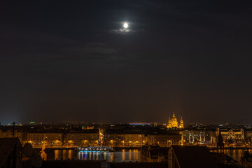 Danube river with lights on and full moon in Budapest winter