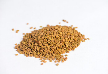 Helba. Background of fenugreek seeds (methi dana, helba or shambala) Helba seeds. Fenugreek on a white background. Healthy herbal tea. Хельба. Gluten-free. Фунгерек. Шамбала. Пажитник. Fungere
