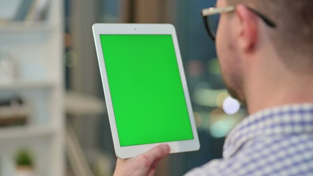 Young Man using Tablet with Chrome Key Screen 