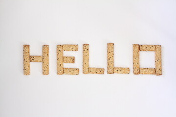 Words HELLO written laid-out with Bread sticks alphabet pretzels isolated on white background