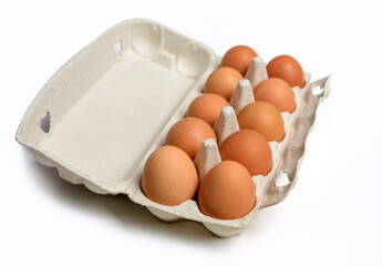 Ten brown eggs in a carton package. Top view. Ten brown eggs in a cardboard box. Eggs.