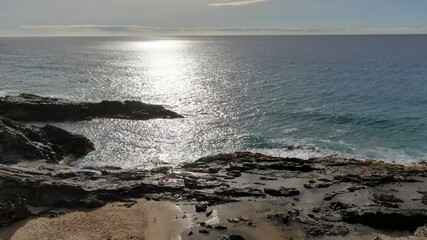 contemplate the sunset and the sea from the cliffs next to the Golden sand