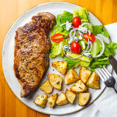 Steak, potatoes and salad