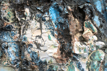 Paint residues on a granite stone wall, close up