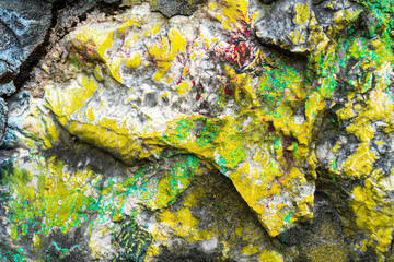Paint residues on a granite stone wall, close up