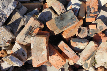 Old broken red bricks lie in a mess background
