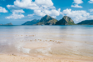 El Nido, Palawan,Philippines. Yacht boat in lagoon of Las Cabanas Beach with amazing mountains in background