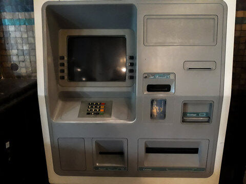 A gray old ATM in the wall. Black frame. Still life in Museum Mandiri.