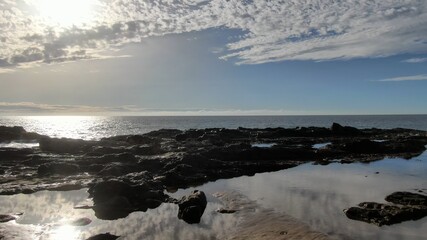 contemplate the sunset and the sea from the cliffs next to the Golden sand