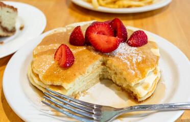 Pancakes with Strawberries, Syrup, and Powdered Sugar 
