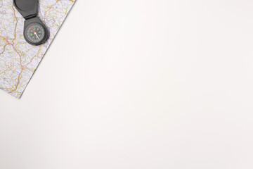 Traveler accessories. Map with compas on white background with empty space for text. Travel vacation concept. Summer background. Flat lay, top view. © Konstantin Maslak