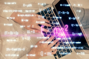 Double exposure of woman hands working on computer and formula hologram drawing. Top View. Science concept.