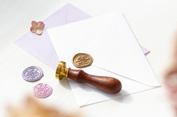 Envelope and wax seal in different colors with the inscription - love. Blur the leaves in the...
