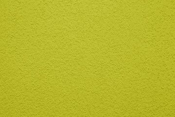 Bright, colorful concrete wall texture, painted background - yellow color. Wallpaper plaster.