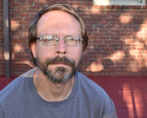 Middle Aged Man with a Beard and Eyeglasses