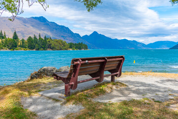 Bench overlooking Wakatipu lake in New Zealand