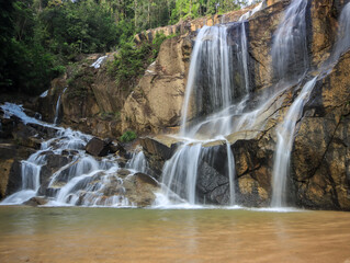 Fototapeta premium Waterfall found in tropical rainforest in malaysia