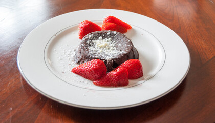 Lava cake with strawberries on table