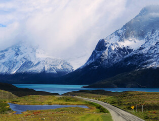 Road near lake and mountains in Torres del Paine National Park, in the Chilean Patagonia