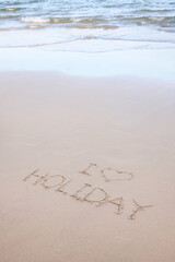 'I love holiday' handwriting word on the beach