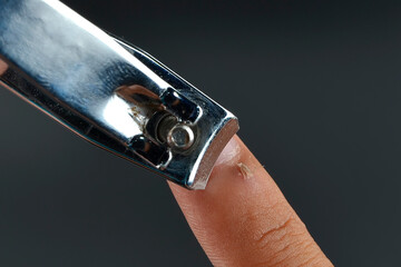 A nail clipper used to trim hangnails isolated on the black background.
