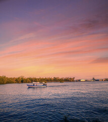 Obraz premium bote en el mar y atardecer 