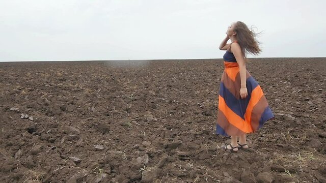 Girl on an Empty Field Moves her Hair
