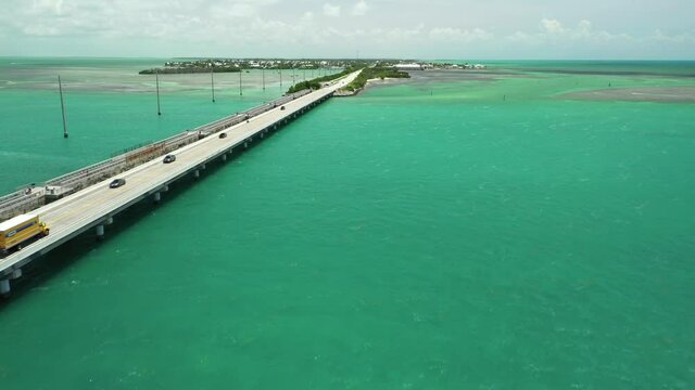 Trucks driving on bridge over water Florida Keys aerial shot